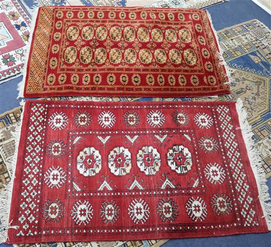 A red ground medallion rug and another 117 x 80cm , 120 x 79cm